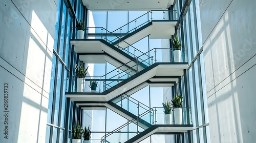 Modern staircase with glass walls in a corporate atrium