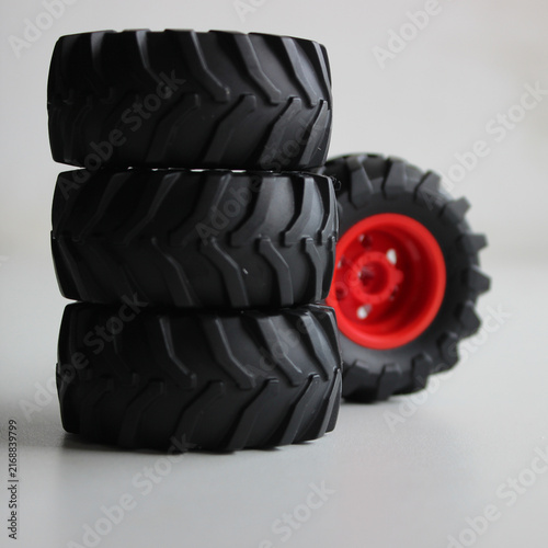 Heavy duty wheel models with aggressive tires stacked on top of each other on a white background