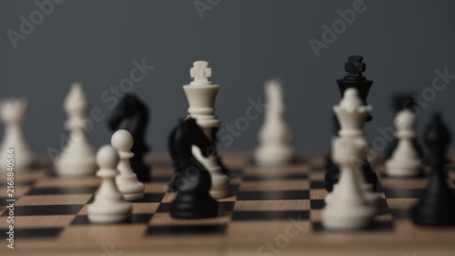 chess on a wooden board going around in circle
