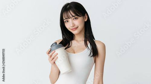 Smiling Fitness Woman Holding Takeaway Drink on Minimal Background