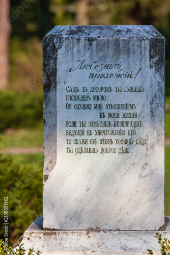 Fotografie Close up view of an old vintage marble monument stone with cyrillic text inscrip