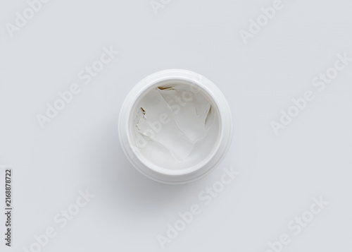Open White Jar with Skincare Cream on White Background