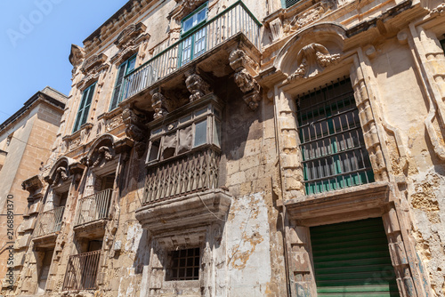 Photography Traditional Maltese wooden balconies and shuttered windows, architectural detail and Mediterranean charm under clear blue sky