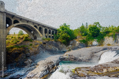 Cascading Spokane Falls with Monroe Street Bridge arch spanning the river gorge in Spokane Washington