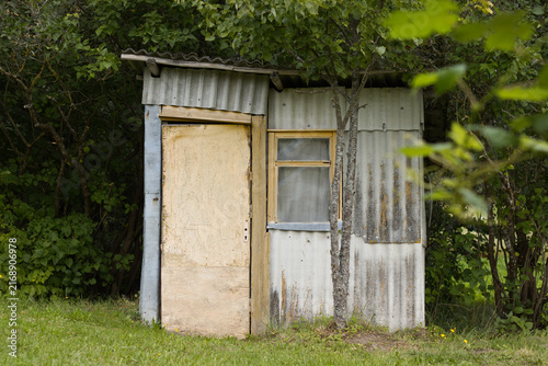 Canvastavla Old abandoned shed among trees