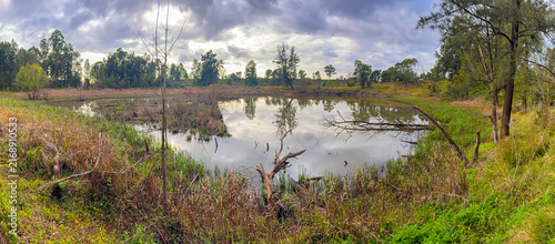 Принти на полотні Photograph of a small water reservoir surrounded by deteriorating bushland at th