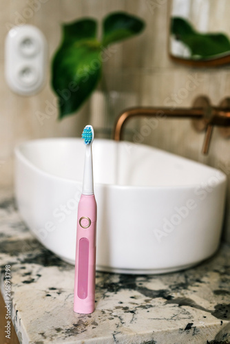 Принти на полотні Sink with toothbrush in hotel bathroom during morning routine