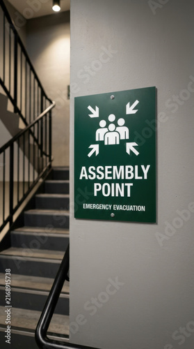 Assembly Point Sign Illustrates Emergency Evacuation Safety Procedures Indoors