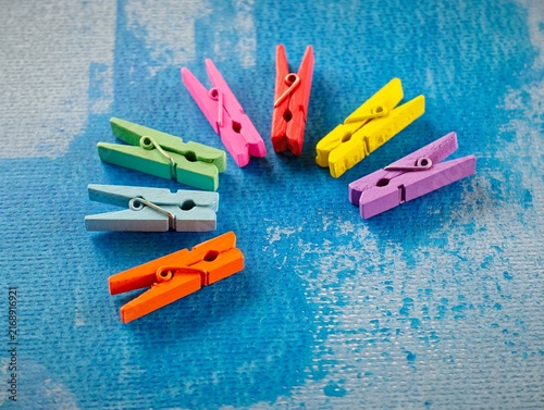 Foto Rainbow Wooden Clothespins Arranged With Copy Space On Blue Background