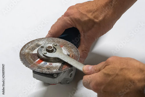 Technician Disassembling an Angle Grinder for Repair and Maintenance
