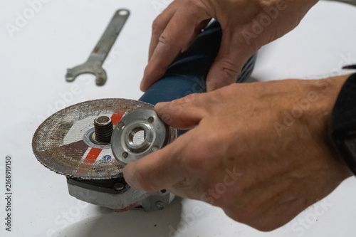 Technician Disassembling an Angle Grinder for Repair and Maintenance