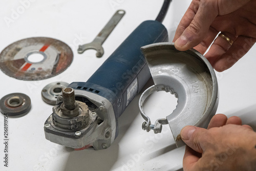 Technician Disassembling an Angle Grinder for Repair and Maintenance