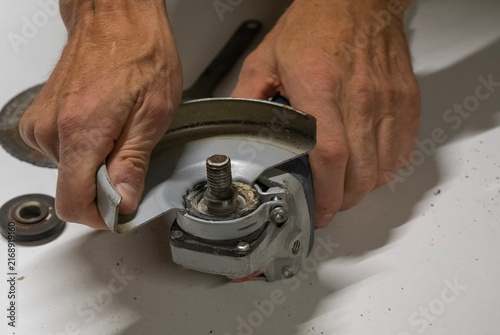 Technician Disassembling an Angle Grinder for Repair and Maintenance