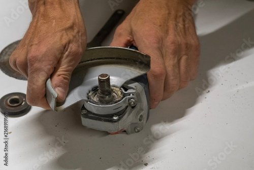 Technician Disassembling an Angle Grinder for Repair and Maintenance