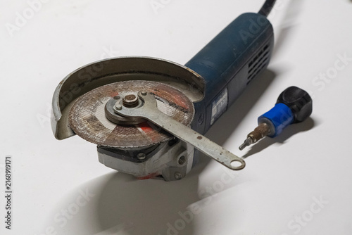 Technician Disassembling an Angle Grinder for Repair and Maintenance