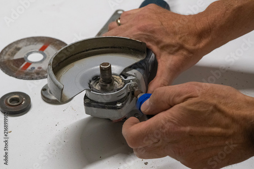 Technician Disassembling an Angle Grinder for Repair and Maintenance