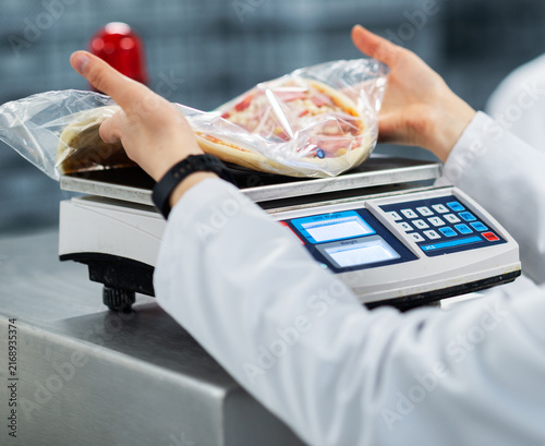 Weighing Packaged Frozen Pizza on Digital Scale