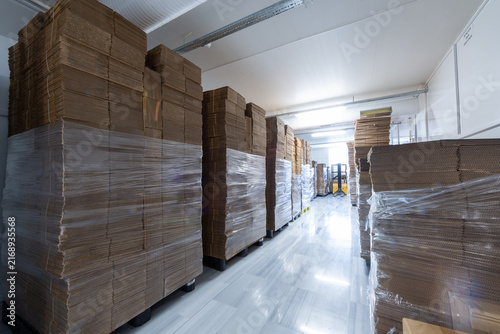 Stacked Corrugated Cardboard Boxes in Warehouse