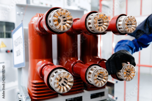 Cuadro en lienzo Technician adjusting high voltage connectors on electrical switchgear