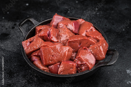 Картината върху платно Raw lamb liver pieces in cast iron pan with thyme, mutton organ meat ingredient