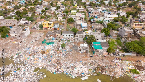 Canvastavla Plastic waste and garbage piling up beside a crowded coastal settlement