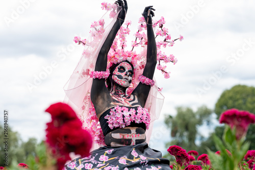 Catrina with Raised Arms Among Red Flowers