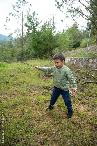 Little boy playing outdoor games in a rural community setting.