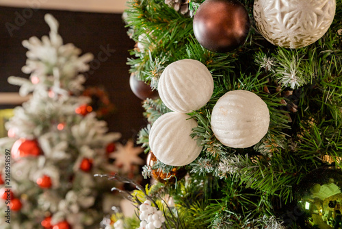 Decorating Christmas tree on bright background, White Christmas ball toy.Merry Christmas, Scandinavian style. Christmas decor. ornaments and garland lights, Christmas holidays background.