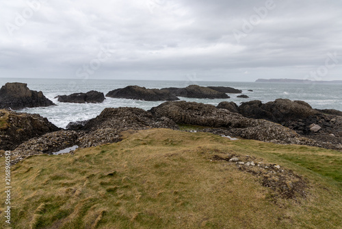 Natural coastal beauty at Ballintoy Point in Northern Ireland with cloudy sky