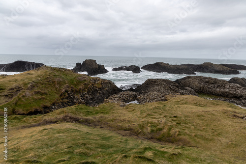 Natural coastal beauty at Ballintoy Point in Northern Ireland with cloudy sky