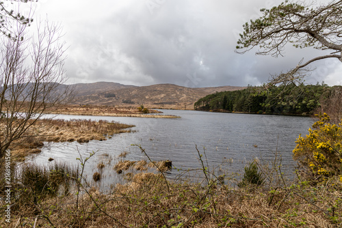Beautiful lake landscape of Lough Beagh with calm waters and rugged Irish hills in the Glenveagh National Park, Ireland.