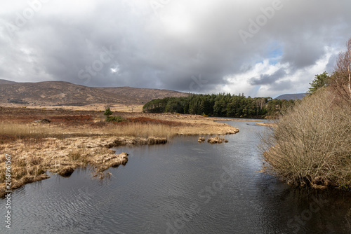 Beautiful lake landscape of Lough Beagh with calm waters and rugged Irish hills in the Glenveagh National Park, Ireland.