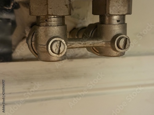 Obraz na plátně Close up view of a metallic connector secured to a wall fixture showcasing its s
