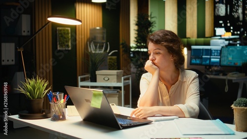 Bild auf Leinwand Businesswoman makes a finance transcription mistake in a notebook tears up the paper and restarts while working late to finish her tasks