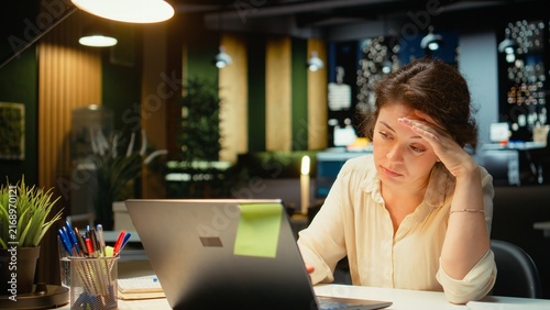 Fotografie Weary employee struggles with mental exhaustion after hours showing intense workload stress fatigue and anxiety in a late-night office setting