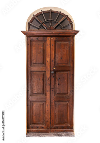 Obraz na płótnie Vintage rustic brown wooden entrance door featuring classic panels, a decorative central molding, and a semicircular arched top window with fan-shaped iron security bars