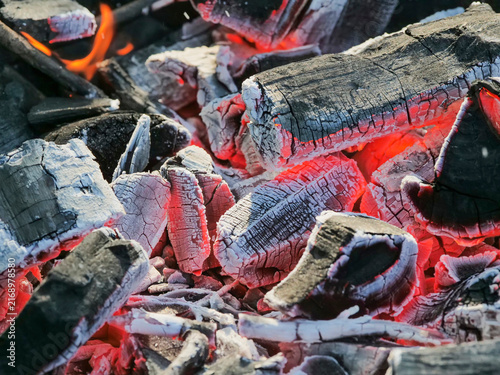 Konstfotografi Close-up of glowing charcoal embers, warm red light, rustic fire for cooking or