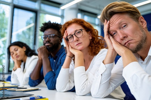 Bored Business People Sitting in Meeting