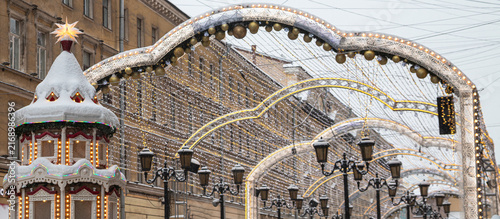 Christmas and New Year decorations in St. Petersburg on Manezhnaya Square, Malaya Sadovaya Street. Arch made of garland. Banner.