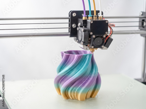 3D Printing Colorful Vase: A state-of-the-art 3D printer meticulously crafts a uniquely designed, colorful vase, showcasing the innovation and creativity in modern manufacturing.