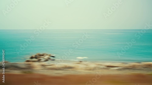 The Calabrian sea and coast in Italy, seen from a train during a summer journey
