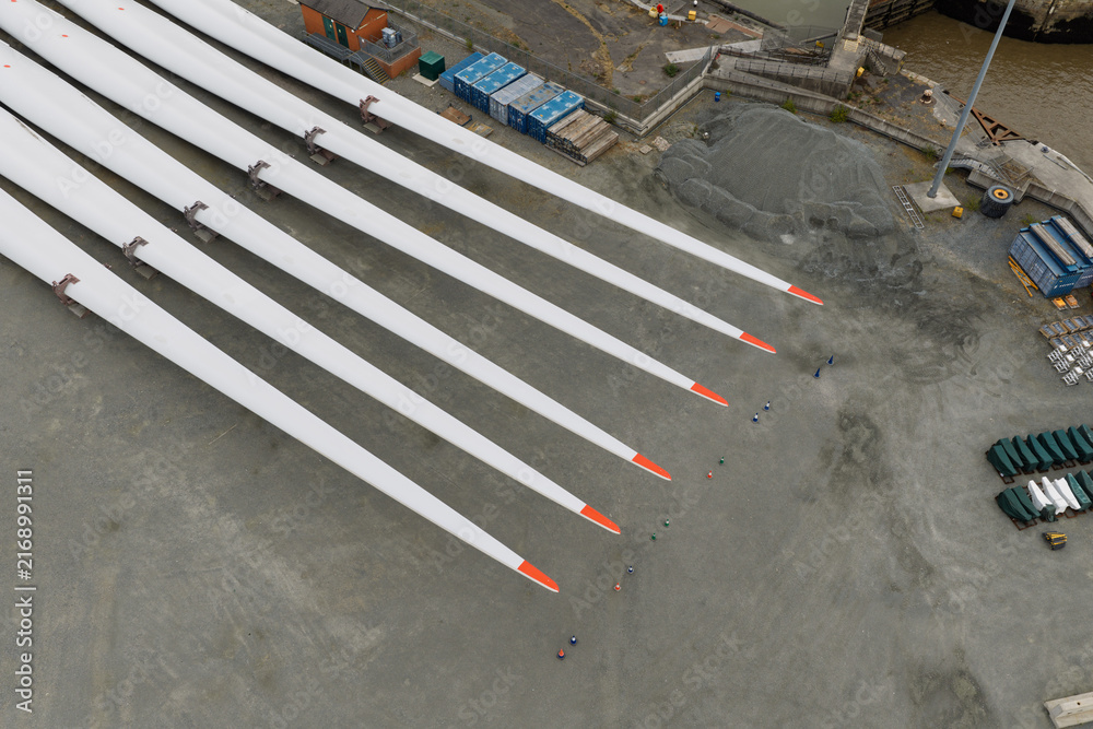 Fototapeta premium Wind Turbine Blades on a Busy Coastal Construction Site