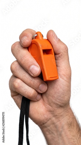 An orange whistle held by a person's hand, ready to signal