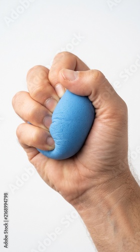 A close-up shot of a person's hand tightly squeezing a blue stress ball, representing the release of tension and frustration