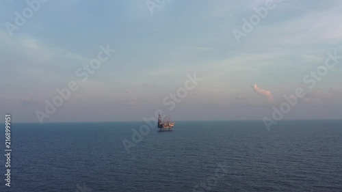 Jack up drilling rig in the middle of the ocean on sunny day
