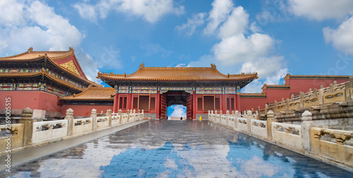 Forbidden City in Beijing, China, Traditional Imperial Palace Architecture with Red Walls and Golden Roofs Under a Blue Sky