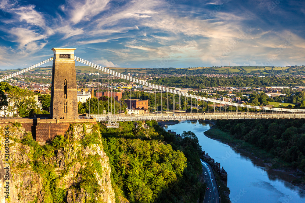 Fototapeta premium Clifton Suspension Bridge at Dramatic Golden Sunset over the River Avon in Bristol, England, UK