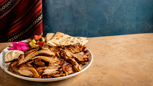 Middle Eastern Chicken Shawarma Plate with Flatbread Pickles and Garlic Sauce