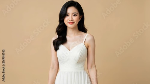 Elegant Bride: A radiant bride in a flowing white gown poses elegantly, her dark, wavy hair cascading around her shoulders.