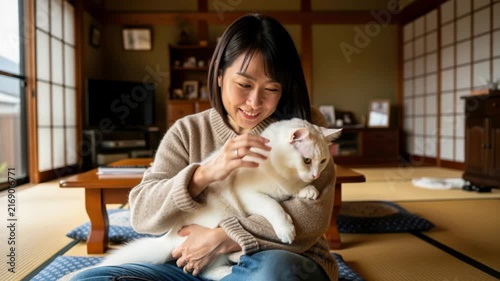 A Moment of Serenity: A young woman tenderly cradles her white cat in a traditional Japanese room, sharing a quiet moment of companionship and affection amidst the warmth of home.